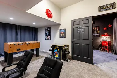 a game room with a ping pong table and chairs at Hibiscus Villa in Orlando