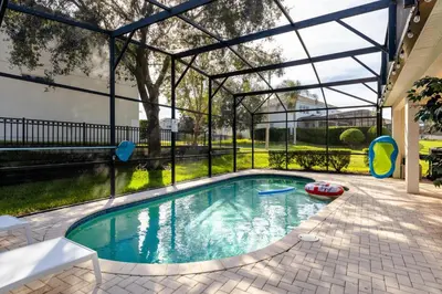 a swimming pool in a house with a glass enclosure at Hibiscus Villa in Orlando
