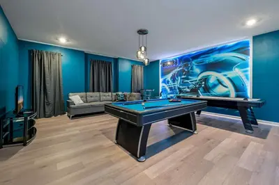a pool table in a room with blue walls at Disney Bliss Themed Rooms Game Room Private Pool in Kissimmee