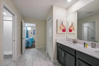 a bathroom with a sink and a mirror at Disney Bliss Themed Rooms Game Room Private Pool in Kissimmee