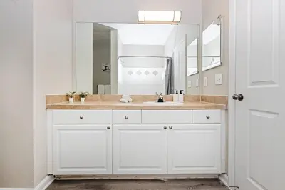 a white bathroom with a sink and a mirror at Orlando Retreat 2B2B / Disney-Universal-SeaWorld in Orlando