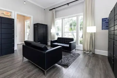 a living room with black furniture and a large window at Orlando Retreat 2B2B / Disney-Universal-SeaWorld in Orlando