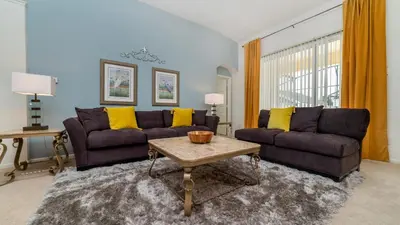 a living room with two couches and a table at 8150 Fan Palm in Kissimmee