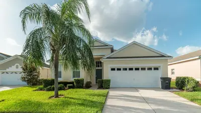 a palm tree in front of a house at 8150 Fan Palm in Kissimmee