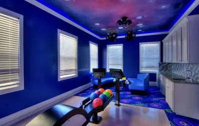 a blue room with a gym with balls on the floor at All Vacation Large Pool Home w-Cinema-Bowling Alley-Sleep 40 in Kissimmee