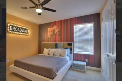 a bedroom with a bed with a sign on the wall at All Vacation Large Pool Home w-Cinema-Bowling Alley-Sleep 40 in Kissimmee