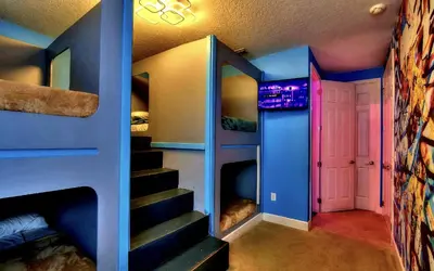 a room with two bunk beds and a staircase at All Vacation Large Pool Home w-Cinema-Bowling Alley-Sleep 40 in Kissimmee