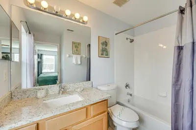 a bathroom with a sink and a tub and a toilet at 7 Mi to Disney Kissimmee Home with Pool and Hot Tub! in Kissimmee