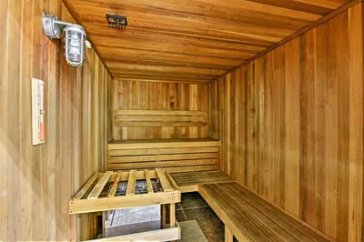 a wooden sauna with a bench in the middle at 7 Mi to Disney Kissimmee Home with Pool and Hot Tub! in Kissimmee
