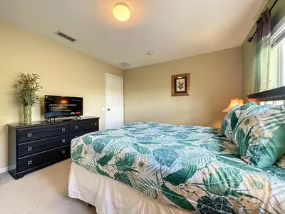 a bedroom with a bed and a flat screen tv at This amazing 6 Bedroom property with a lake view in Orlando