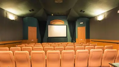 an empty auditorium with a screen in a theatre at Immaculate 4 bedrooms 3 bathroom in Windsor Palms in Kissimmee