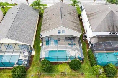 an aerial view of a house with a swimming pool at Tropical and peaceful, this 5 bed with Pool & Spa in Orlando