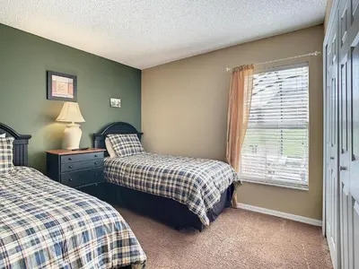 a bedroom with two beds and a window at Emerald Island Resort 4 bed 3 bath with pool/spa in Kissimmee