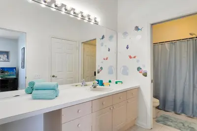 a bathroom with a sink and a mirror at Windsor Palms 3 bed Condo in Gated Resort in Kissimmee