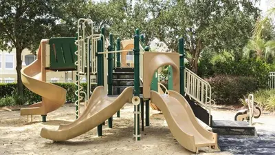 a playground with a slide in a park at Windsor Palms 3 bed Condo in Gated Resort in Kissimmee