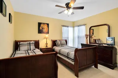 a bedroom with two beds and a ceiling fan at Fantastic Resort 5BR House - South Facing Pool/Spa in Kissimmee