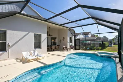 an indoor swimming pool with a glass roof at Fantastic Resort 5BR House - South Facing Pool/Spa in Kissimmee