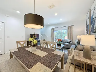 a dining room and living room with a dining table at Amazing Townhouse close to Disney 2 Bed 2.5 Bath in Kissimmee