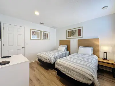 a bedroom with two beds and a desk with a desk at Amazing Townhouse close to Disney 2 Bed 2.5 Bath in Kissimmee