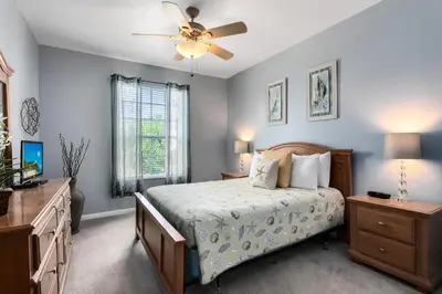 a bedroom with a bed and a ceiling fan at Close to Disney Condo 3 Bed / 2 Bath in Kissimmee