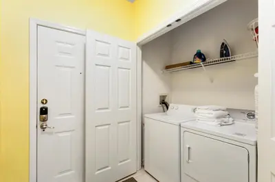 a white laundry room with a washer and dryer at Close to Disney Condo 3 Bed / 2 Bath in Kissimmee