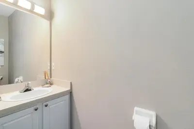 a bathroom with a sink and a mirror at Disney Area 4 bed/ 3.5 Bathroom Emerald Island in Kissimmee