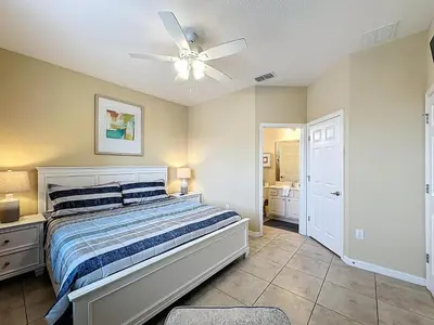 a bedroom with a bed and a ceiling fan at Veranda Home, 8br, 6 en-suites, Lake View,POOL/SPA in Kissimmee