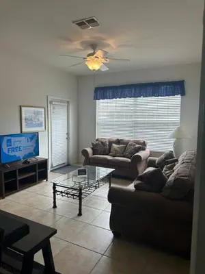 a living room with two couches and a tv at Amazing Resort 2 bed condo close to Disney in Kissimmee