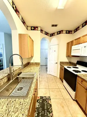 a kitchen with a sink and a stove at Amazing Resort 2 bed condo close to Disney in Kissimmee