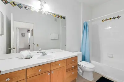 a white bathroom with a sink and a toilet at Amazing Resort 2 bed condo close to Disney in Kissimmee