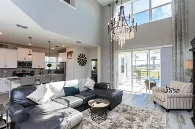 a living room with a couch and a table at Five bedroom home is ideal for an elegant vacation in Kissimmee