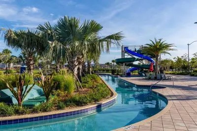 a pool at a resort with a slide at Five bedroom home is ideal for an elegant vacation in Kissimmee
