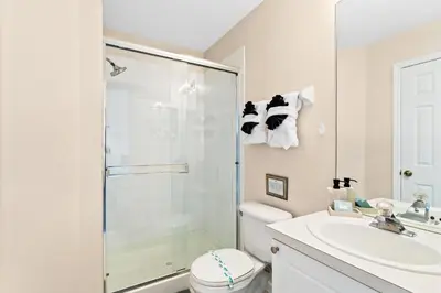 a bathroom with a shower and a toilet and a sink at South Facing Pool 4 Bedroom 3 Bath Villa in Kissimmee