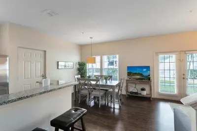 a kitchen and dining room with a table and chairs at Lucaya Village Resort - 4 Bed 3 Bath Townhouse in Kissimmee