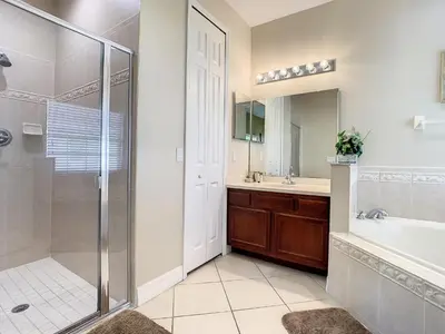 a bathroom with a shower and a sink at Fantastic 7 Bed 6 Bath in Prestigious Gated Comm. in Orlando