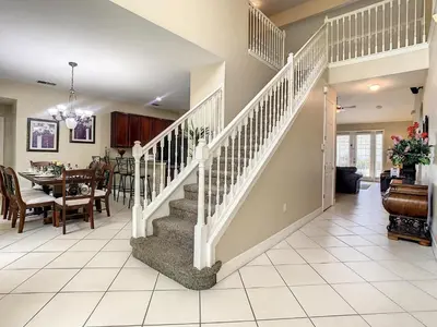 a staircase in a home with a dining room at Fantastic 7 Bed 6 Bath in Prestigious Gated Comm. in Orlando