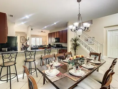 a dining room and kitchen with a table and chairs at Fantastic 7 Bed 6 Bath in Prestigious Gated Comm. in Orlando