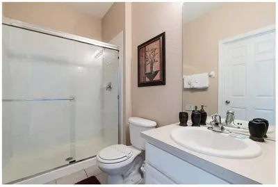 a bathroom with a toilet and a sink and a shower at Three BR * 2 Miles to Disney, pool, free WiFi in Orlando