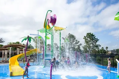 a water park with people playing in a fountain at Three BR * 2 Miles to Disney, pool, free WiFi in Orlando