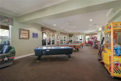 a play room with a pool table and arcade games at Three BR * 2 Miles to Disney, pool, free WiFi in Orlando