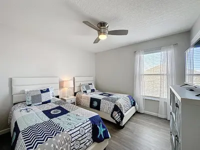 a bedroom with two beds and a ceiling fan at Amazing 6 Bed Disney Dream Getaway in Windsor Palm in Kissimmee