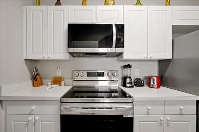 a kitchen with a stove and a microwave at Making Memories Resort Windsor Palms Condo in Kissimmee
