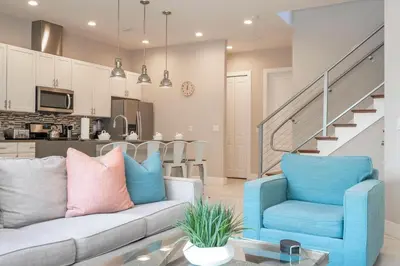 a living room with a couch and chairs and a kitchen at 5 Min to Disney Dream 5 Suites Villa in Orlando