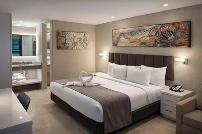 a bedroom with a large bed and a bathroom at Orlando International Drive North Hotel in Orlando