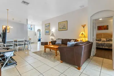 a living room with a couch and a table at 3Br 2Ba Private Pool Villa just steps away from villa in Kissimmee