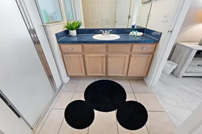 a bathroom with a sink and a black rug on the floor at Star Oasis At Citrus Ridge By Shine Villas 091 in Orlando