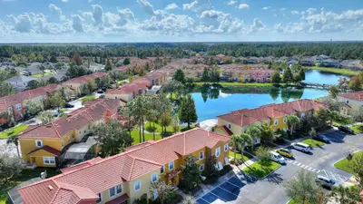 an aerial view of a residential neighbourhood with a lake at Zen Escape At Terra Verde By Shine Villas in Kissimmee