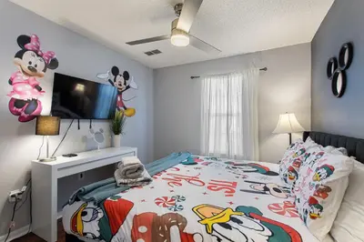a bedroom with a mickey mouse bed and a television at Zen Escape At Terra Verde By Shine Villas in Kissimmee