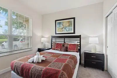 a bedroom with a bed with a stuffed animal on it at Priceless Peace At Serenity By Shine Villas 081 in Orlando