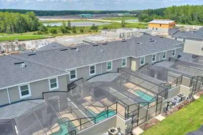 an aerial view of a house with a swimming pool at Plush Pelican, At Storey Lake By Shine Villas #839 in Kissimmee